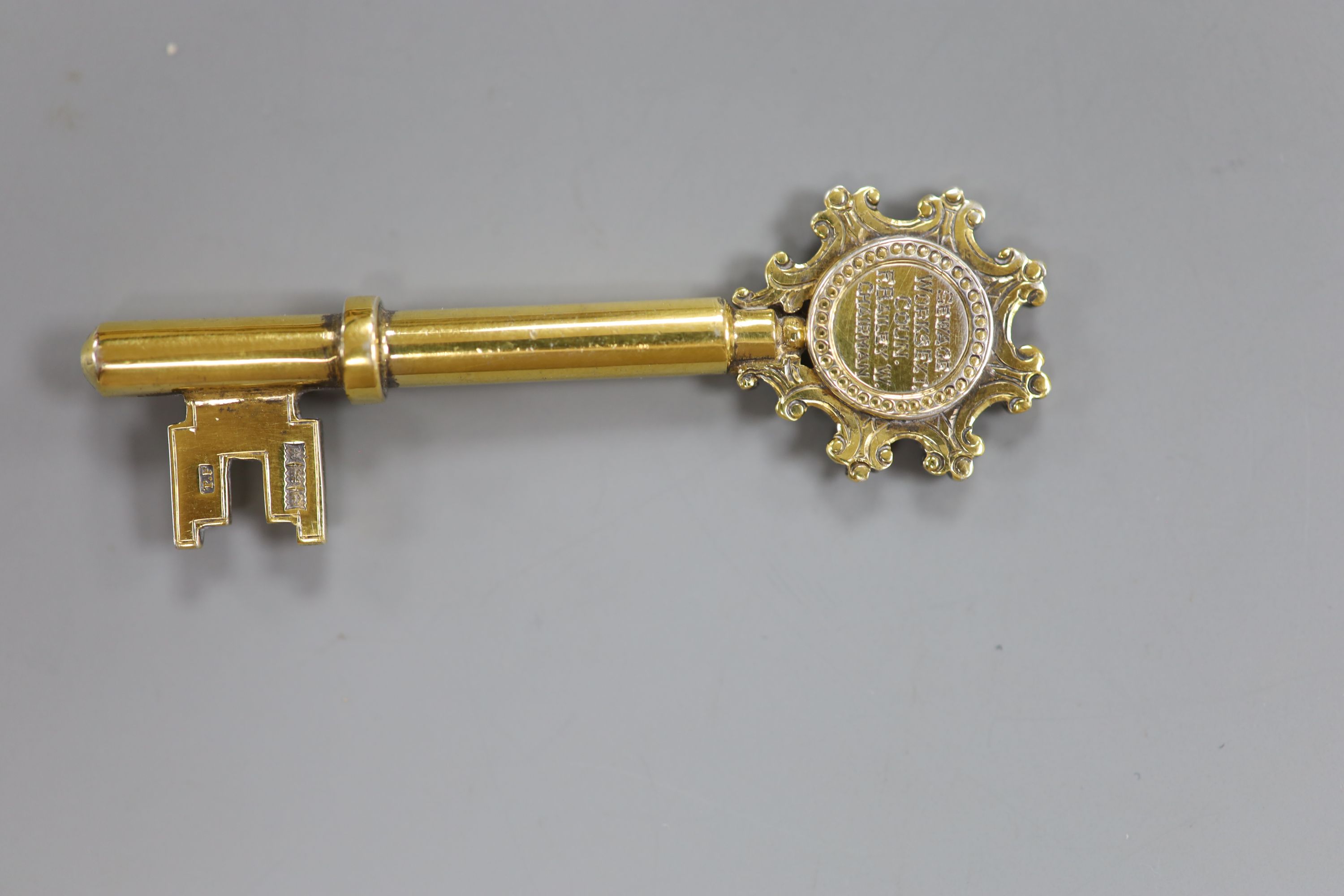 A modern silver gilt presentation key, Birmingham, 1961, 67mm, with engraved inscription.